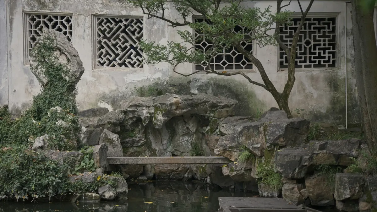 A garden pond, scholar rocks, and lattice windows in Suzhou