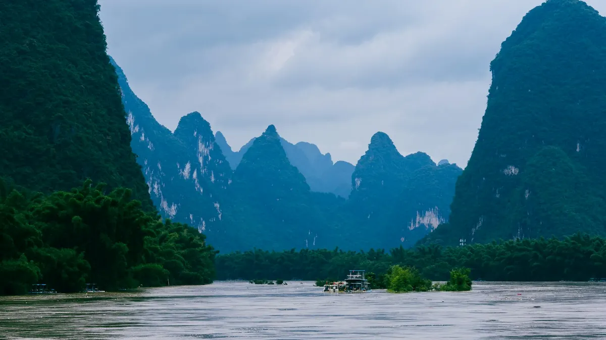 A boat on the Li River with karst peaks in Yangshuo